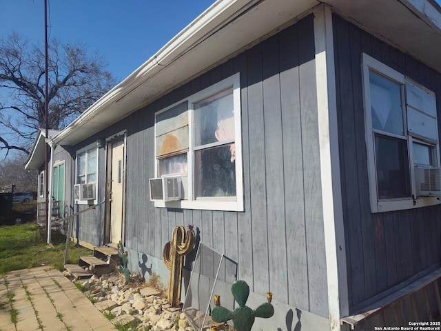 view of side of home featuring cooling unit