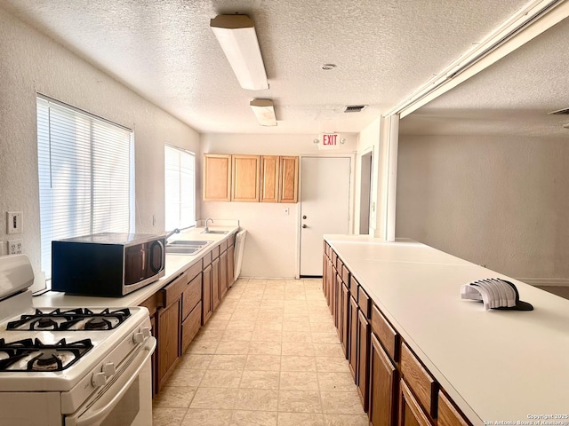 kitchen featuring sink and white gas range oven