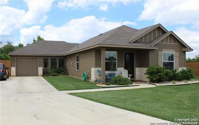 view of front of property featuring a garage and a front lawn