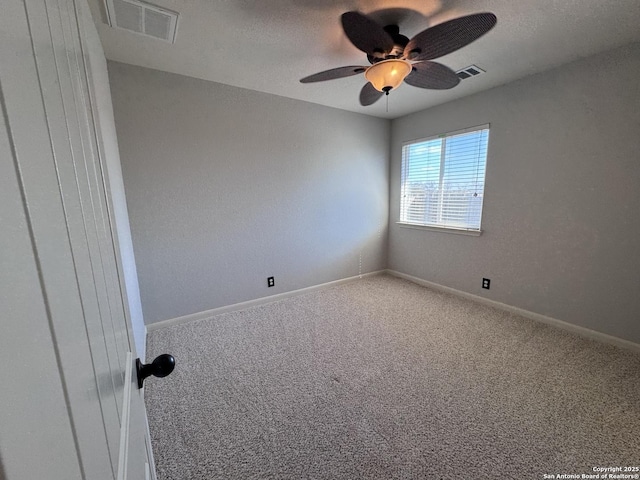 carpeted empty room featuring a textured ceiling and ceiling fan