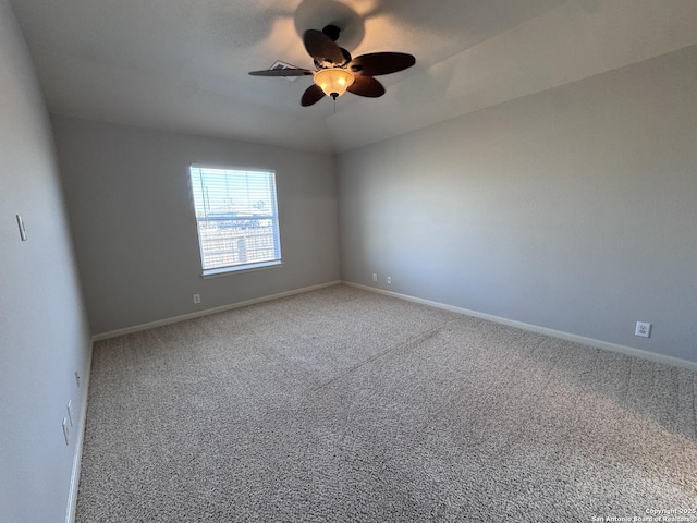 empty room featuring vaulted ceiling, ceiling fan, and carpet flooring