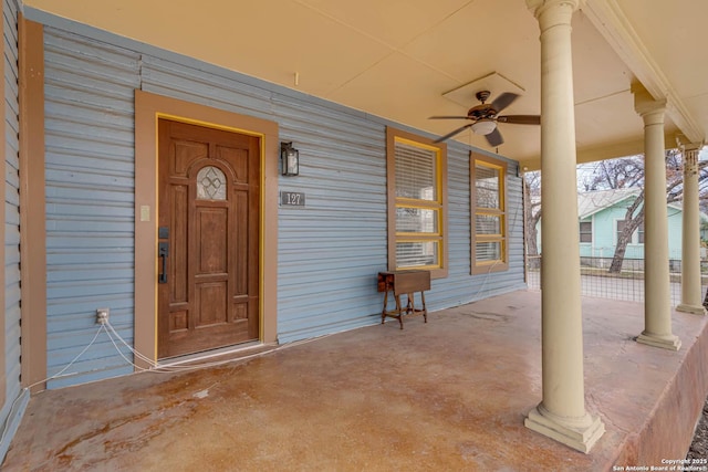 view of exterior entry with covered porch and ceiling fan