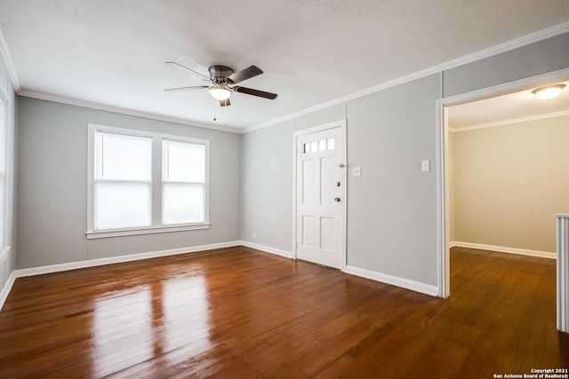 entrance foyer featuring dark wood-type flooring, ornamental molding, and ceiling fan