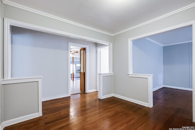 empty room with crown molding and dark hardwood / wood-style flooring