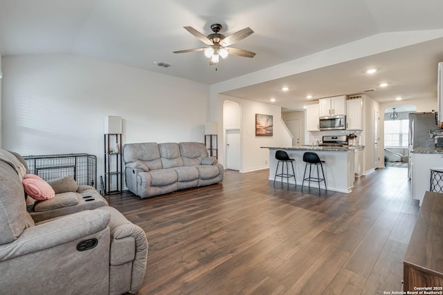 living room with lofted ceiling, dark hardwood / wood-style flooring, and ceiling fan