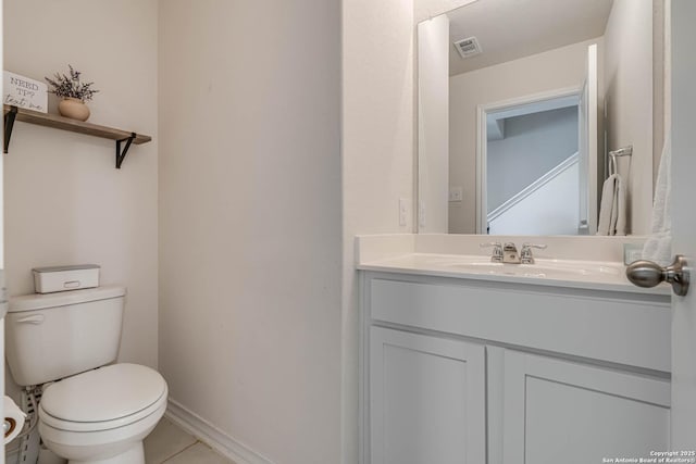 bathroom with tile patterned floors, toilet, and vanity