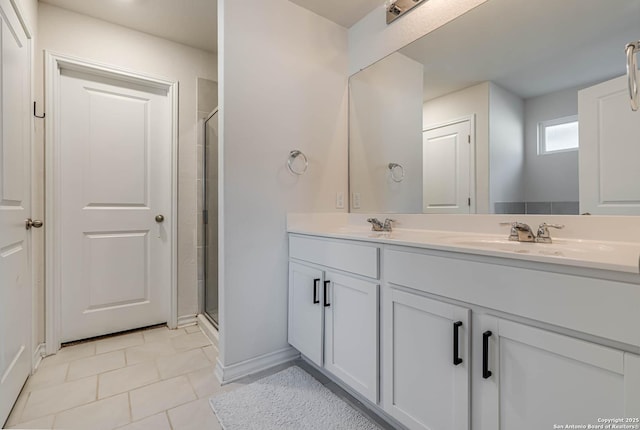 bathroom with vanity, a shower with shower door, and tile patterned flooring