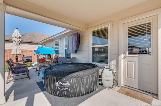 view of patio / terrace with an outdoor living space and a hot tub