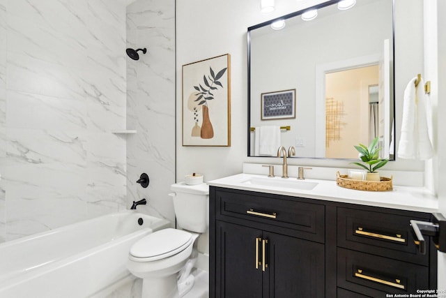 full bathroom featuring vanity, tiled shower / bath combo, and toilet