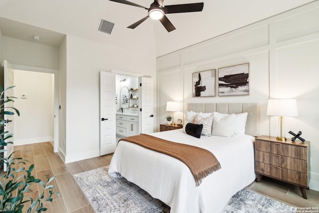 bedroom with ceiling fan and ensuite bath