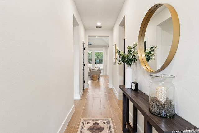 hallway with light hardwood / wood-style flooring