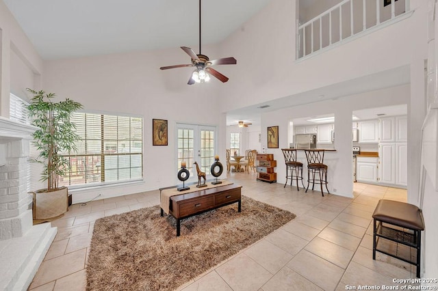 living room featuring french doors, ceiling fan, and light tile patterned flooring