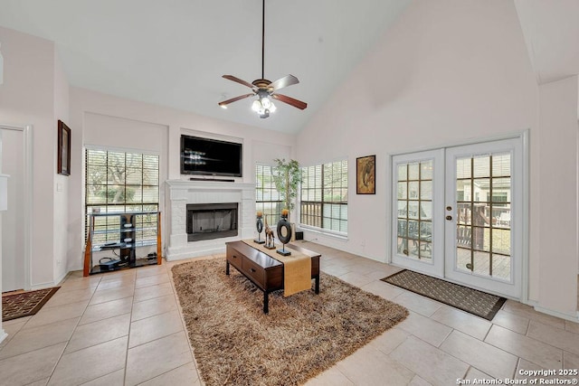 living room with light tile patterned floors, high vaulted ceiling, french doors, and ceiling fan