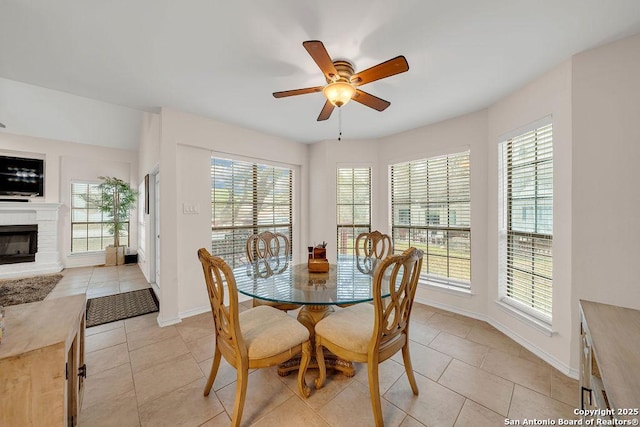 dining space featuring light tile patterned flooring, ceiling fan, and a wealth of natural light