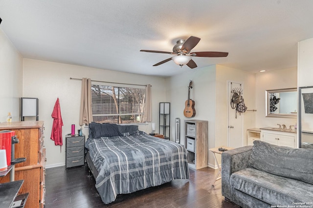 bedroom featuring dark wood-type flooring, a textured ceiling, and ceiling fan