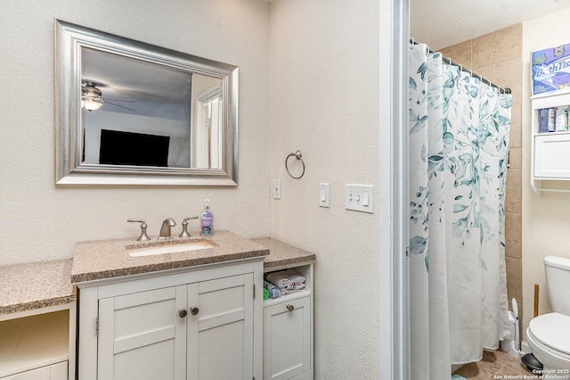 bathroom with ceiling fan, vanity, toilet, and a shower with shower curtain