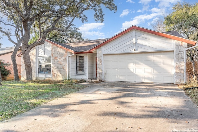 ranch-style house with a garage and a front lawn