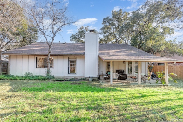 rear view of property featuring a yard and a patio