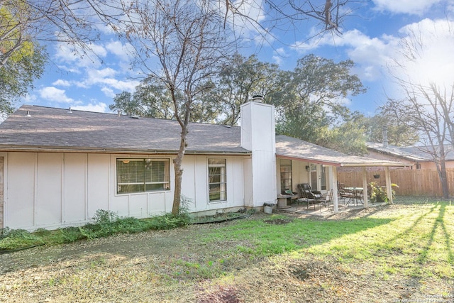 back of house featuring a yard and a patio