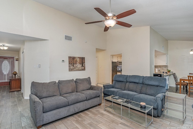 living room with ceiling fan and lofted ceiling