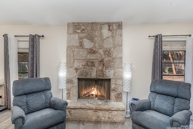 living room with a fireplace and light wood-type flooring