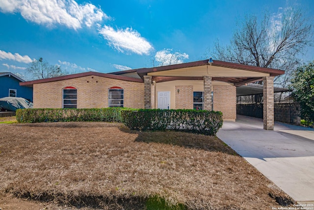 single story home featuring a carport and a front yard