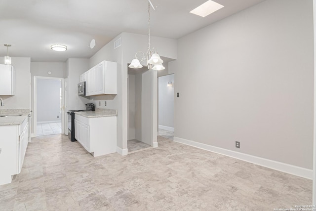 kitchen featuring white cabinetry, hanging light fixtures, black electric range, and sink