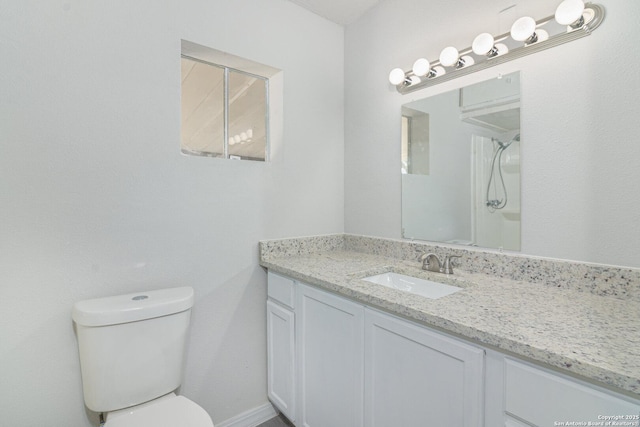 bathroom featuring vanity, a shower, and toilet