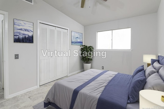 bedroom with ceiling fan, lofted ceiling, and a closet