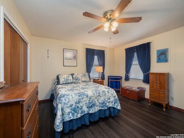 bedroom with dark hardwood / wood-style floors and ceiling fan