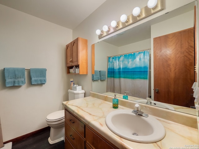 bathroom with vanity, toilet, curtained shower, and wood-type flooring