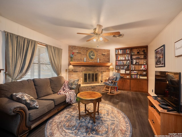 living room with ceiling fan, dark hardwood / wood-style floors, and a fireplace