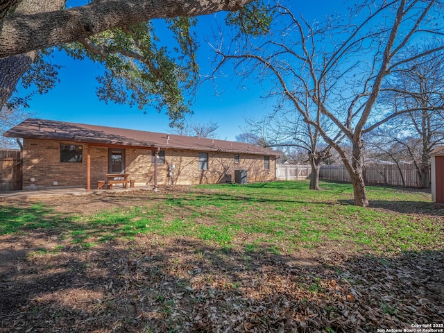 back of house featuring a lawn and a patio