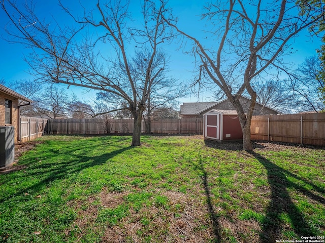 view of yard featuring a shed and central air condition unit