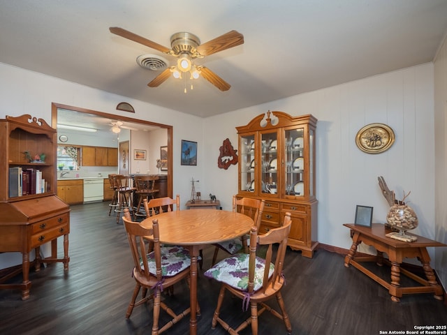 dining area with ceiling fan, dark hardwood / wood-style floors, and sink