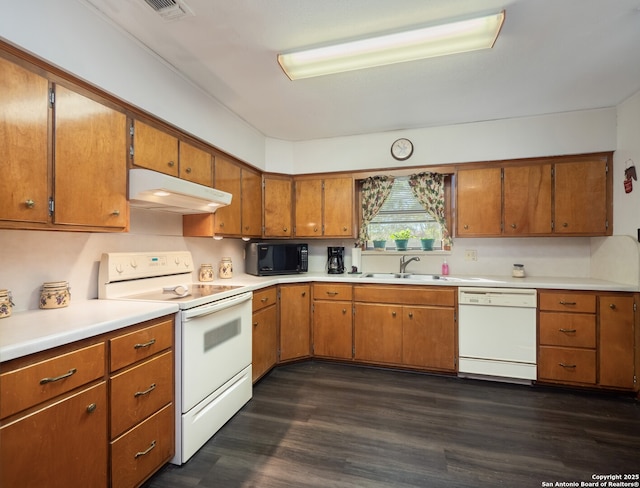 kitchen featuring dark hardwood / wood-style flooring, sink, and white appliances