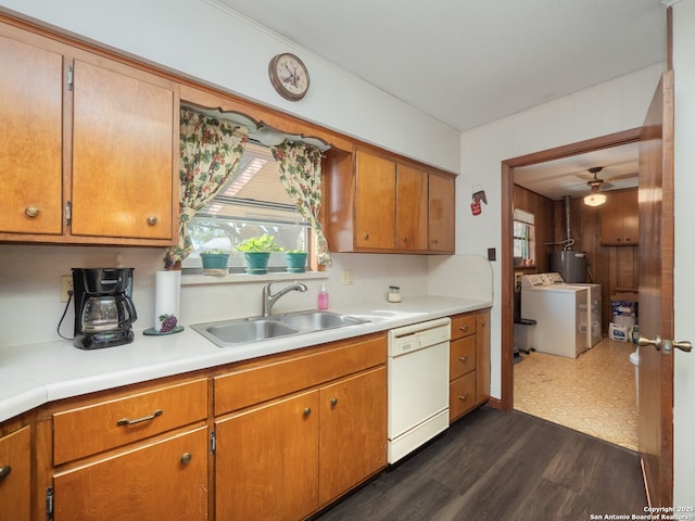 kitchen with white dishwasher, sink, plenty of natural light, and washing machine and dryer