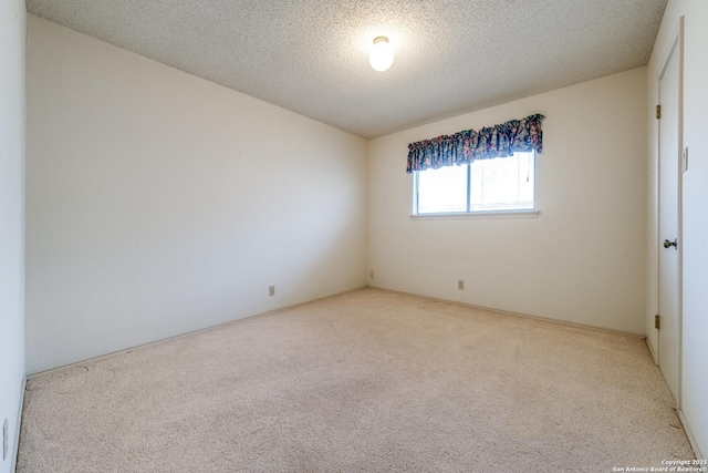 carpeted spare room with a textured ceiling