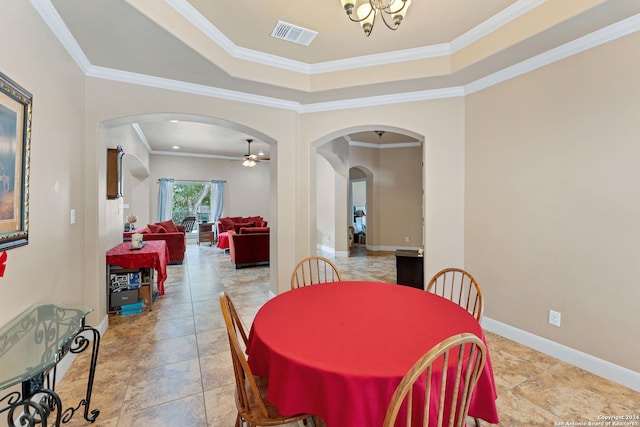 dining space featuring ceiling fan, ornamental molding, and a raised ceiling