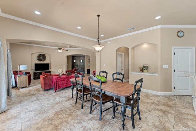 tiled dining space featuring crown molding and ceiling fan