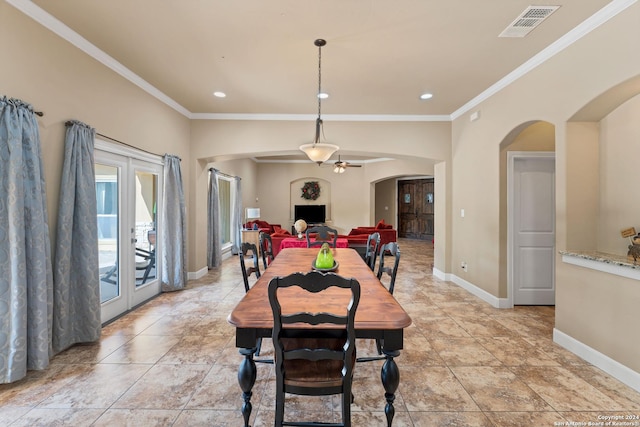 dining room featuring crown molding, ceiling fan, and french doors