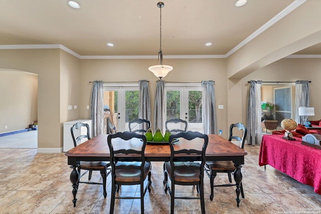 dining area with ornamental molding and french doors