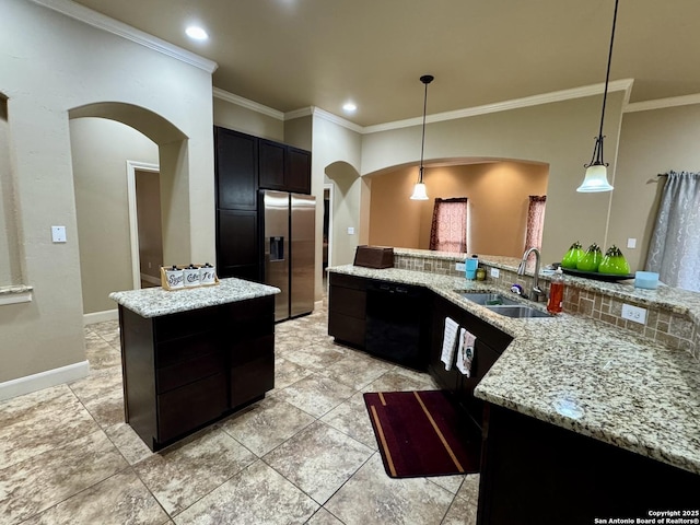 kitchen with pendant lighting, sink, a center island, stainless steel fridge with ice dispenser, and light stone countertops