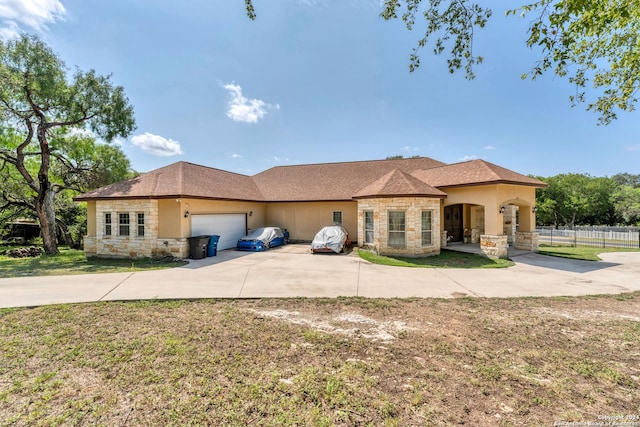 view of front of home featuring a garage and a front lawn