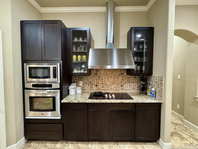 kitchen with light stone counters, appliances with stainless steel finishes, tasteful backsplash, and wall chimney range hood