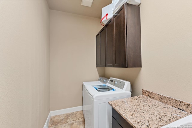 washroom featuring cabinets and washer and dryer