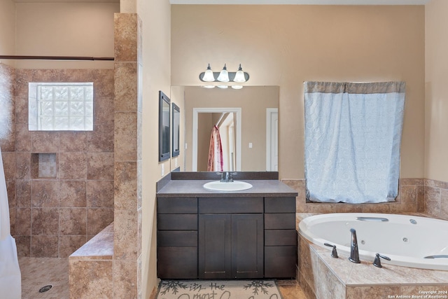 bathroom featuring vanity and tiled bath