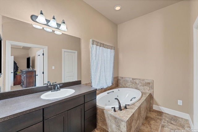 bathroom with vanity and tiled bath