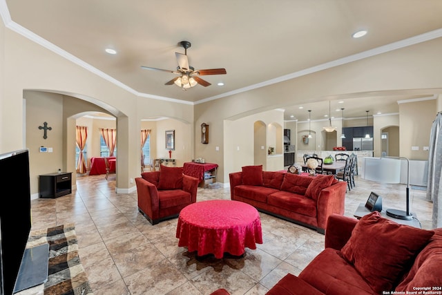 living room featuring light tile patterned floors, ornamental molding, and ceiling fan