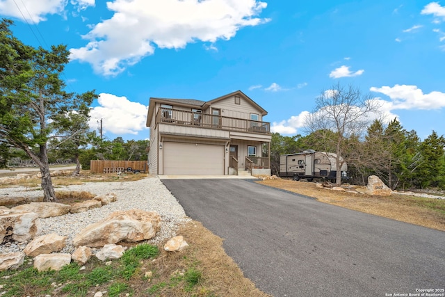 view of front of house featuring a garage and a balcony